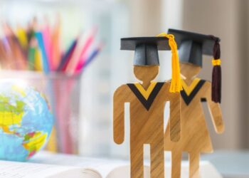 America Education knowledge learning study abroad international Ideas. Student Sign wood with Graduation celebrating cap on open textbook with model global map,alternative studying world wide